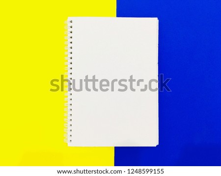 Notes book with yellow and blue background. View from top