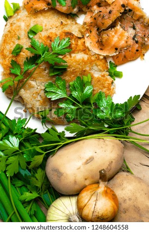 potato pancakes with salted salmon and parsley, onion, pepper