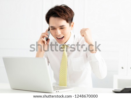 young businessman working with laptop in office