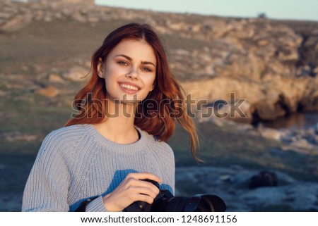 Cheerful female photographer in nature                       