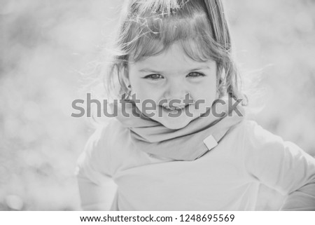 Happy girl with cute face smile on sunny day on bokeh natural landscape. Child, childhood concept