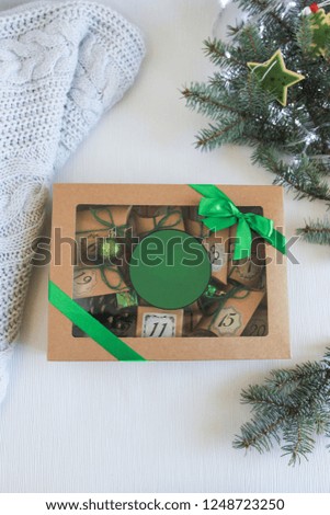 Merry Christmas gift box. Flat lay compositions with present box and advent calendar, decorated with cup of tea, cookies. Place for your text