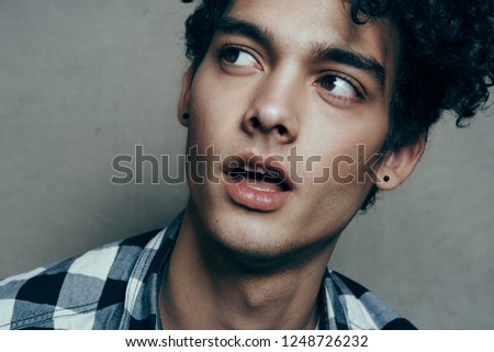 Curly guy with open mouth looking to the side                              