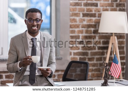 African american businessman drinking coffee in office 