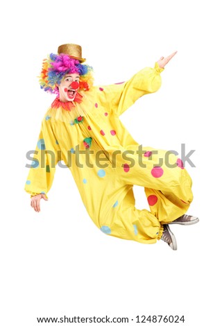 Full length portrait of a male clown jumping isolated on white background