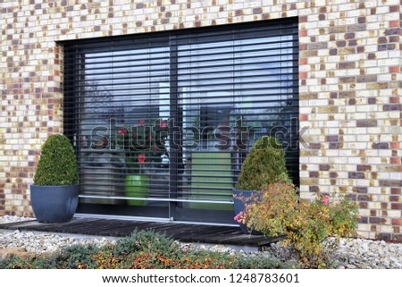 Window with modern blind, exterior shot Royalty-Free Stock Photo #1248783601
