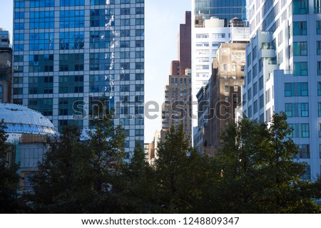 (selective focus) Close-up view of some huge buildings and beautiful skyscrapers in Manhattan, New York City, USA.