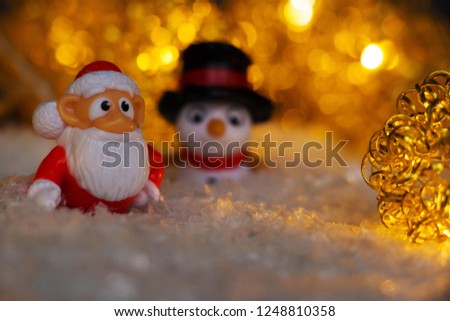Christmas figures in the snow - Santa Claus, a penguin and a snowman
