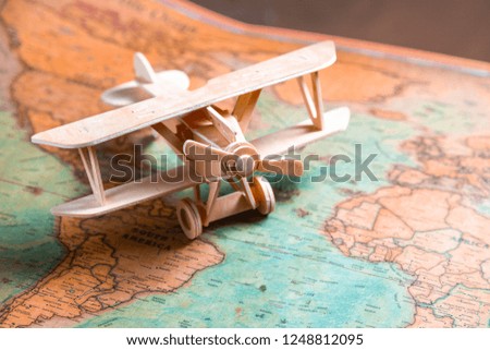 Wooden model aircraft on the background of the map