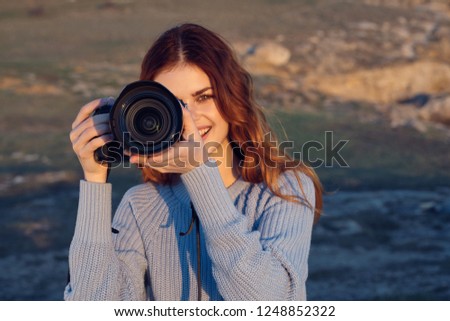 Woman photographer with a camera in nature                