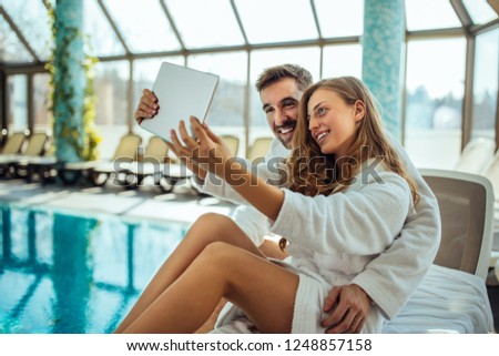 Lovely couple taking a selfie at spa resort