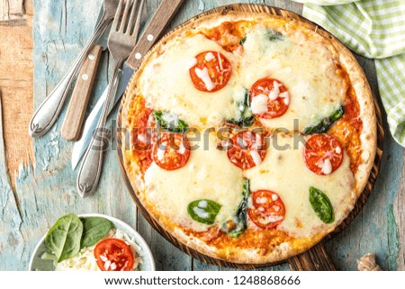 pizza margarita top view on a rustic wooden table, Margherita  cooked according to the traditional recipe of Italian cuisine
