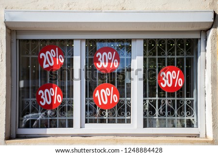 on glass showcases in the store information about discounts, sale before Christmas, new year holidays, notification of buyers pasted on window, passion for shopping, consumer society, goods, clothing