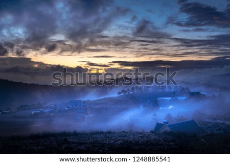 A magical image of a clouded valley in the early morning when the aurora appears in Dalat town, Viet Nam