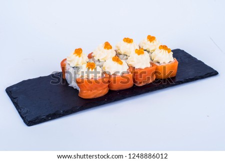 
sushi with salmon and caviar, philadelphia cheese, lay on a plate