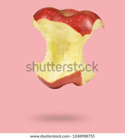 Bitten red apple isolated on pink background, minimalism
