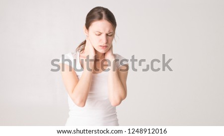 Tired woman feeling neck pain, massaging tense muscles