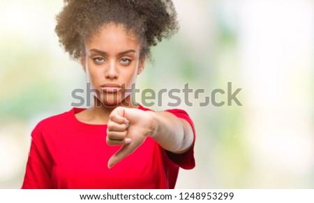 Young afro american woman over isolated background looking unhappy and angry showing rejection and negative with thumbs down gesture. Bad expression.