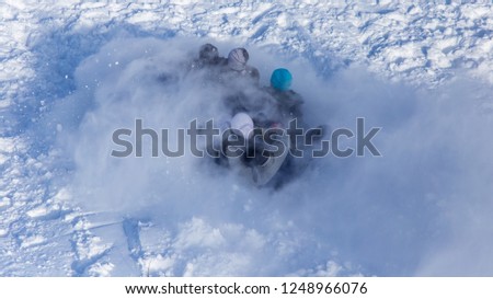 People sledding from the mountain in winter .