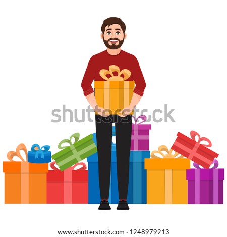 A man holds a gift, a lot of gifts in the background, happy man
