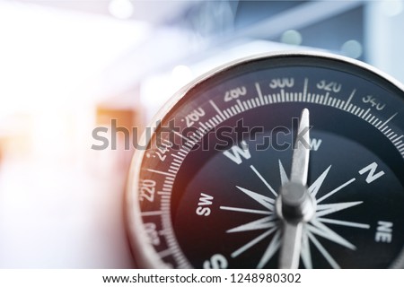 holding compass on tree mountain and sea blurry background. Using wallpaper or background travel or navigator image. Royalty-Free Stock Photo #1248980302