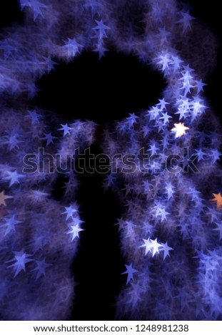 Christmas stars  background, special bokeh effect on black, silhouetted person