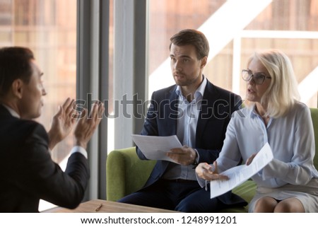 Dissatisfied woman financier director criticizing financial report or wrong agreement accusing man employee, colleague deny his guilt. Unqualified worker conflict problems and mistakes at work concept Royalty-Free Stock Photo #1248991201