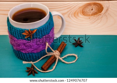 Cristmas theme - big  bright tea cup and cinnamon roll, wooden snowflakes