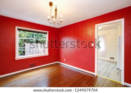 Red dining room interior of a remodeled craftsman style house.