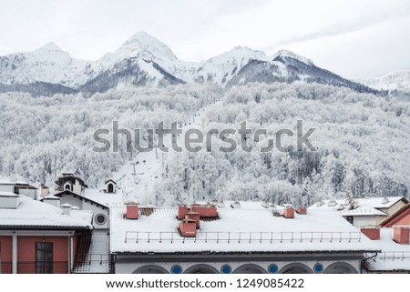 ski resort: mountain view with lift and roofs of colorful houses