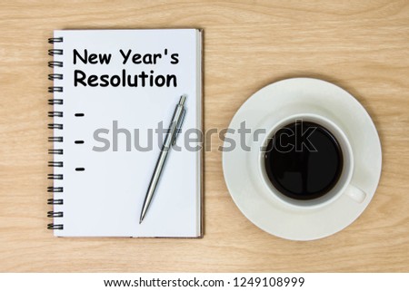 2020 goals on paper book and hot coffee cup wood background. New Year's Resolution 2020 on book and wooden background. target success concept. top view.