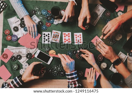 Young Friends Playing Poker on Party at Home. Playing Games. Indoor Fun. Young Girl. Young Guy. Sitting at Table. Party with Friends. Indoor Activities Concept. Gambling. Card Games. Royalty-Free Stock Photo #1249116475