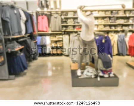 Blurred motion golf apparel, accessories and gear section at sport retail store in America