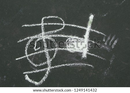 child's drawing of music notes on ground