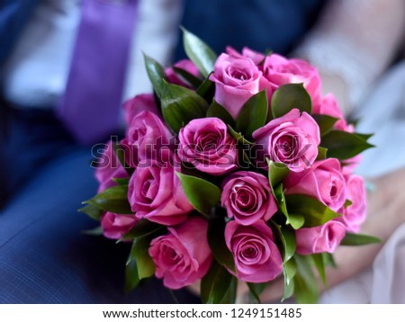 Beautiful and bright flowers. Beautiful bouquet of purple roses on the table in the interior.
