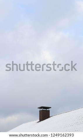 Roof covered with snow and blue sky. White. Snow picture. 