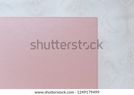  photo book with  leather cover close up. pink photo album with copy space for text. Photoalbum with a hard cover.
background for photo publishing.
sample photobook.