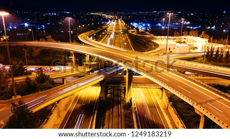 Aerial drone slow shutter night shot of urban elevated toll ring road junction and interchange overpass passing through National Road and Attiki odos, Attica, Greece