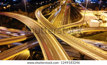 Aerial drone slow shutter night shot of urban elevated toll ring road junction and interchange overpass passing through National Road and Attiki odos, Attica, Greece