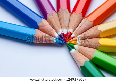 Colorful pencils on the office table in a rainbow color pattern