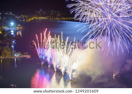 colorful fireworks shots on the lake during a summer event