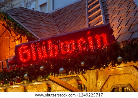 A sign for mulled wine is on top of a stall at the Nibelungen Christmas Market. The Christmas market in Worms, Germany is held under the motto Nibelungen Christmas, ref. to the Song of the Nibelungs.