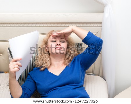 A woman feels bad because of menopause. Hot flashes, sweating, dizziness, irritability. Menopause concept. Harmonious restructuring of the body. Royalty-Free Stock Photo #1249229026