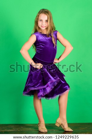 Kid dancer satisfied with concert outfit. Kids fashion. Kid fashionable dress looks adorable. Girl cute child wear velvet violet dress. Clothes for ballroom dance. Ballroom dancewear fashion concept.