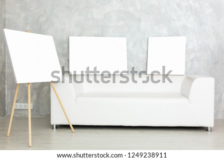 wall art canvas in three parts. Sofa, in room interior.