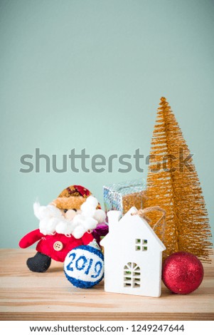 Christmas background. A small gold Christmas tree and boxes with gifts on a wooden table. Green background. Space for text. New Year's background.