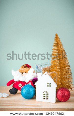 Christmas background. A small gold Christmas tree and boxes with gifts on a wooden table. Green background. Space for text. New Year's background.