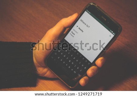 type text on keypad. where to on a white smartphone screen close up. 
choice nearby destination 