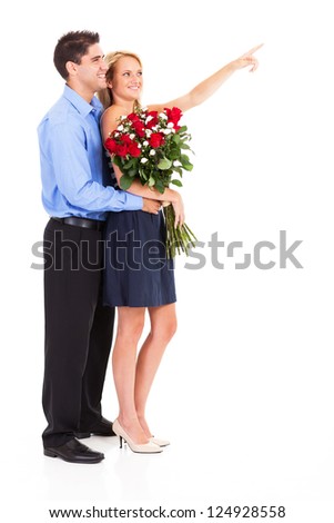 happy couple with bunch of roses isolated on white, woman is pointing