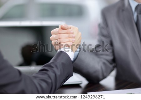 close up. two businessmen are engaged in arm wrestling at a Desk
